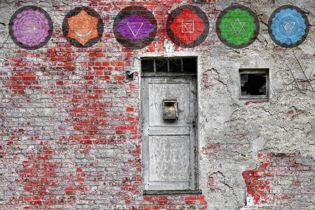 gekleurde chakra symbolen op stenen muur